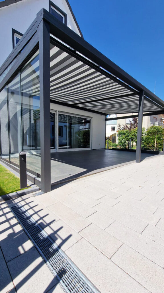 Terrassenüberdachung aus Glas mit Unterdachmarkise